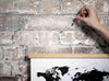 Hanging a Magnetic Poster Frame with World Map Art Print on a Brick Wall