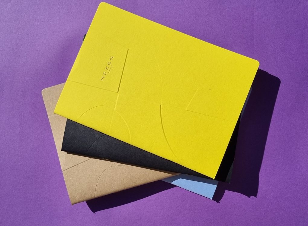Angled view of MOXON B5 ‘Form’ notebooks in multiple colours with strong sunlight contrast