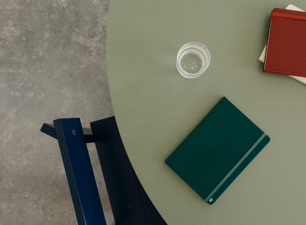 Karst hardcover A5 notebooks stacked on a table. Made with environmentally friendly stone paper.