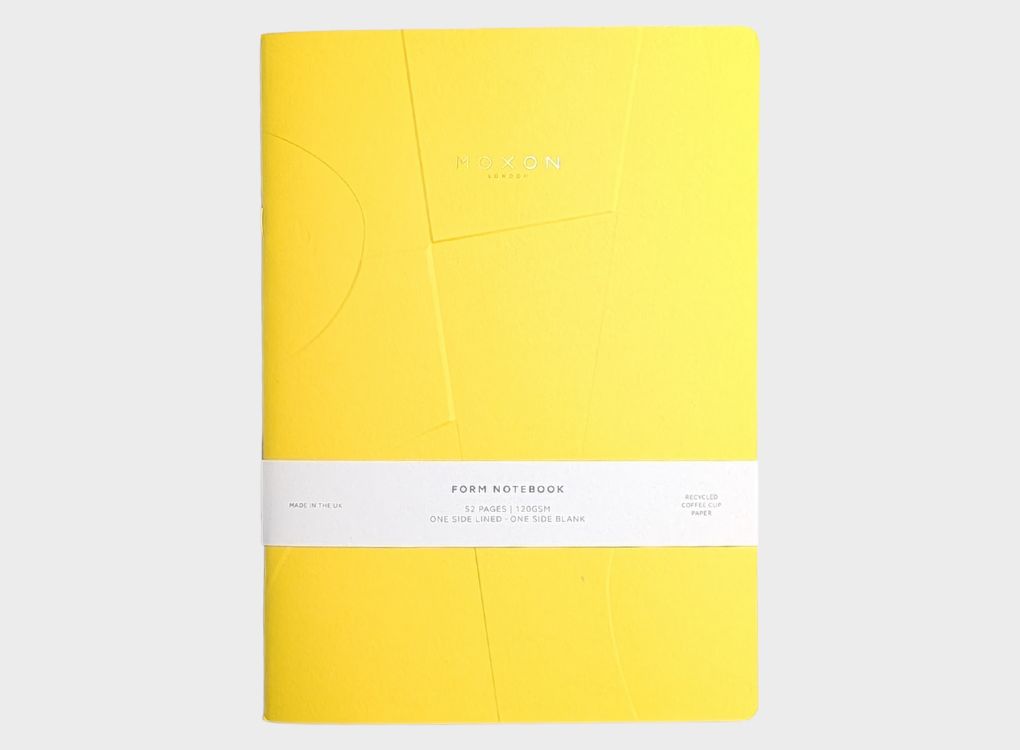 Yellow MOXON B5 ‘Form’ notebook with packaging band displayed on a neutral background
