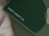 Close-up of the &quot;From Little Things&quot; variant of the 2026 MiGoals A5 Weekly Notes Diary. The dark green cover features bold white text reading &quot;TWENTY-TWENTY SIX&quot; with abstract geometric shapes in muted green and blush tones.