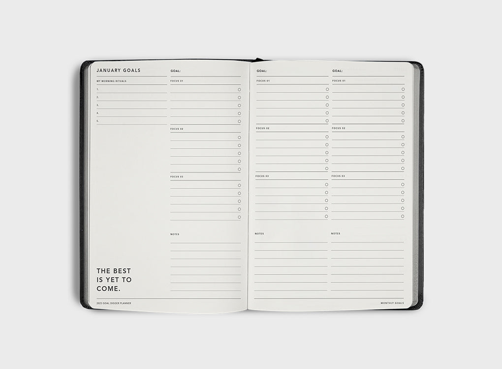 MiGoals 2026 Classic Diary in sea green with embossed “Goal Digger Planner 2026” on the cover, styled on a stone tray with a coffee cup and fabric backdrop.