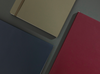 Flat lay of Olive green, navy, and burgundy Karst notebooks with vegan leather soft covers