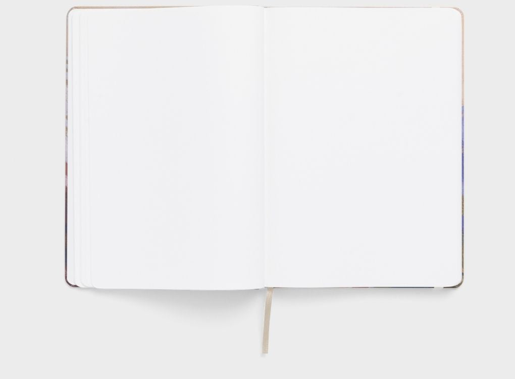 Open Karst limited edition Mandy Maria hardcover notebook showing blank stone paper pages with ribbon bookmark.