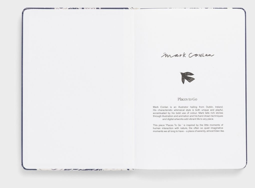 Karst limited edition Mark Conlan hardcover notebook with navy and white illustrated cover featuring whimsical nature and travel-inspired scenes.