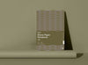 A Studio Muse A5 hardcover notebook by Karst with an olive green and lavender geometric patterned cover, standing against a matching olive green background. The notebook features smooth, recycled stone paper with lined pages and a slim, lightweight cover.