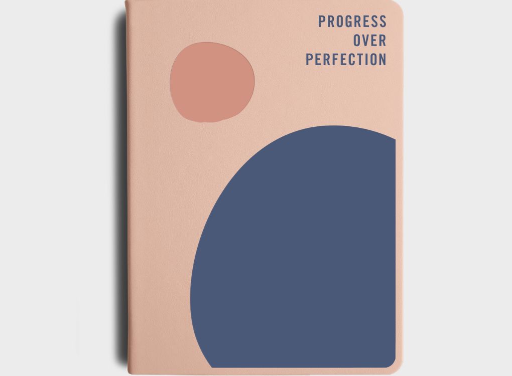 MiGoals 2026 Classic Diary in sea green with embossed “Goal Digger Planner 2026” on the cover, styled on a stone tray with a coffee cup and fabric backdrop.