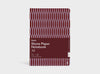 A Studio Muse A5 hardcover notebook by Karst with a maroon and lavender geometric patterned cover, displayed against a plain white background. The notebook features smooth, recycled stone paper with lined pages and a slim, lightweight cover.