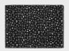 areaware cairo throw in black and white, laid flat, a large jacquard blanket-style throw with a contemporary print from old typefaces. A contemporary and interesting home accessory
