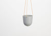 CAPRA DESIGNS HANGING PLANTER - STONE  IS SKILLFULLY HAND MADE FROM RESIN AND FINISHED WITH TAN LEATHER. Each planter has a hole in the bottom for drainage and a plug for convenience. Worldwide shipping. Free UK shipping.