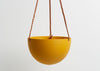The GOLDEN BLOCK COLOR DOME HANGING PLANTER IS SKILLFULLY HAND MADE FROM RESIN AND FINISHED WITH TAN LEATHER The planter has a hole in the bottom for drainage and a plug for convenience. Designed in Australia. Worldwide shipping. Free UK shipping.
