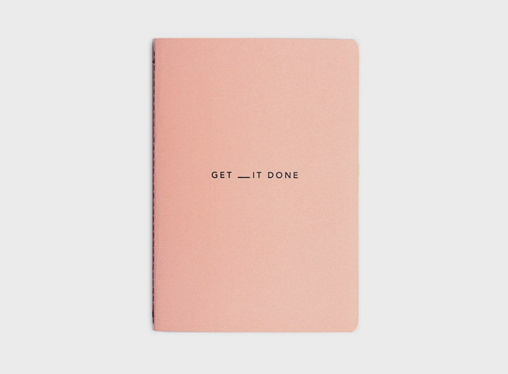 MiGoals Get It Done motivational notebook in khaki on black on a grey background. A versatile notebook designed to motivate you.