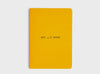 MiGoals Get It Done motivational notebook in yellow and black on a grey background. A versatile notebook designed to motivate you.