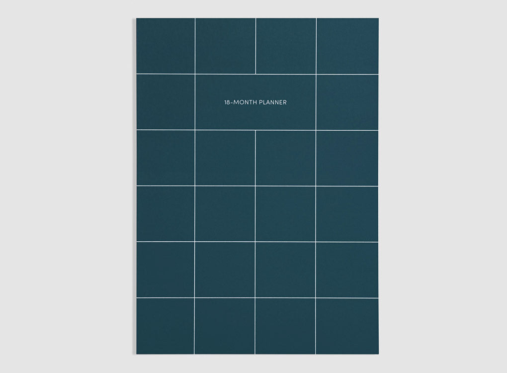 Poketo 18 month undated planner with weekly spread in bright pink, with a white grid pattern and white text, on a grey background. Smart, versatile stationery